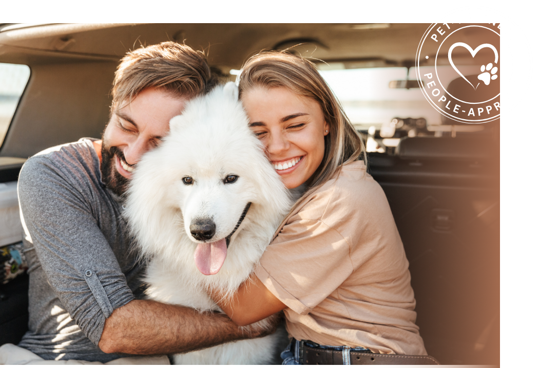 Two people hugging a dog